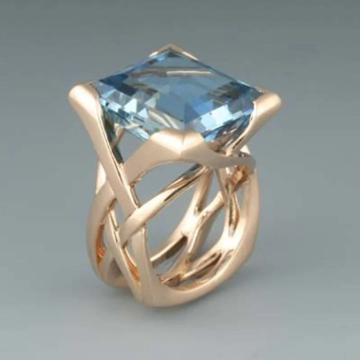 Anillo de oro rosa con circonitas azules